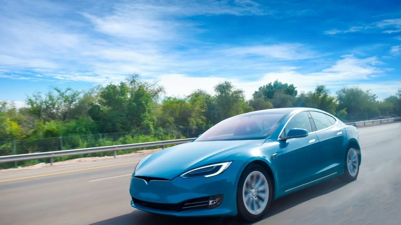 Close up on a plate of mashed potatoes, topped with baked pork chops with cream of mushroom soup, and a side of green beans.