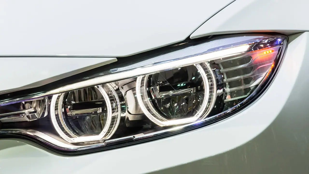 blue bowl of black bean beef tortilla soup on a board with cilantro and shredded cheese in background