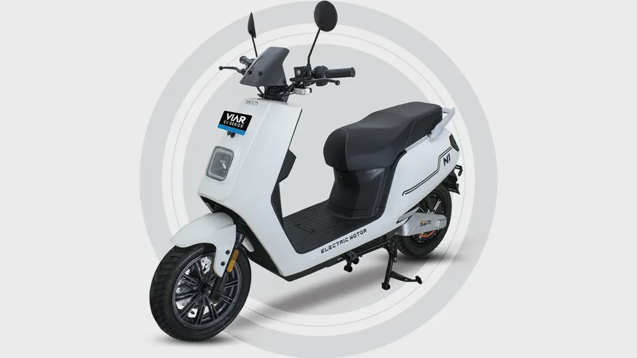 Close up on a plate of mashed potatoes, topped with baked pork chops with cream of mushroom soup, and a side of green beans.