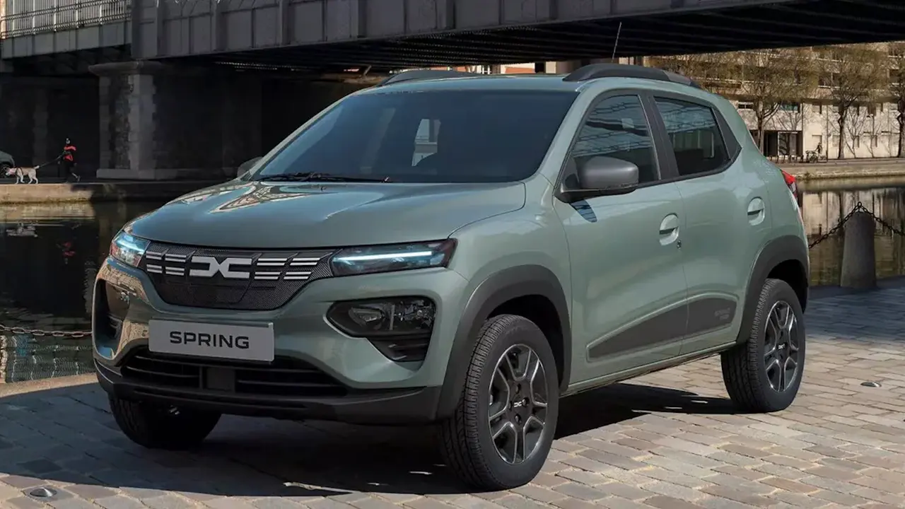 Close up on a plate of mashed potatoes, topped with baked pork chops with cream of mushroom soup, and a side of green beans.