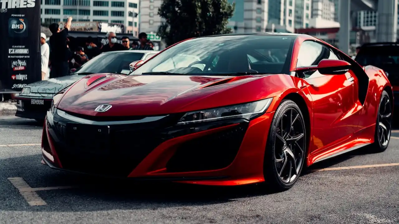 Two mint chocolate milkshakes with whipped cream and green sprinkles.